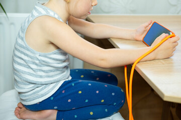 young girl Hunched over mobile device, child neglects physical posture, negative effects With neck...