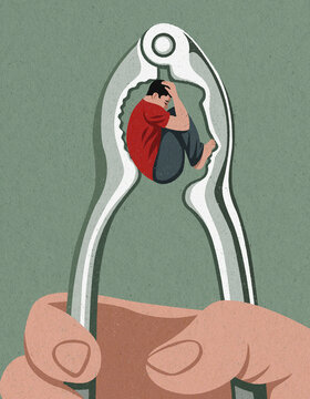 Teenage boy curled up inside head shaped nutcracker