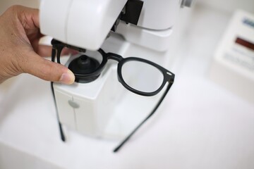 Hand holding glasses in eyeglasses store