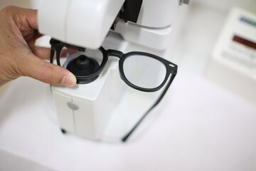 close up of a doctor holding a glasses 