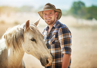 Portrait, farmer and man with horse, smile and sunshine with nature, happiness and environment....