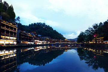 Fototapeta premium lake como country Ancient Feng Huang city at sunset in Hunan, China - Architectural background