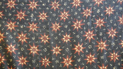 Close up of a colorful batik cloth pattern on black background.. Thai silk fabric pattern, Thai...