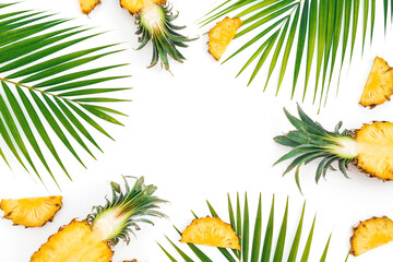 Fototapeta premium Tropical frame with pineapple and palm tree leaves on white background. Flat lay, top view.