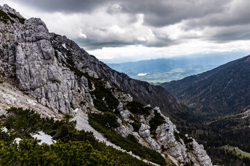 Begunjščica panorama of mountain trekking to the highest peak. View of the Alps, climbing with via ferrata. Distant view of Lake Bled from above. Sports holidays, life of adventure in the countryside