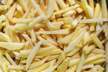 Peeled and chopped potatoes before cooking. Sliced natural potatoes close-up