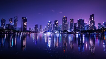 Fototapeta premium Sparkling cityscape reflecting off a tranquil river in the dead of night