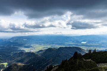 Fototapeta premium Begunjščica panorama of mountain trekking to the highest peak. View of the Alps, climbing with via ferrata. Distant view of Lake Bled from above. Sports holidays, life of adventure in the countryside