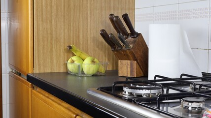In cucina ceppo portacoltelli con angolo cottura e frutta mele e banane