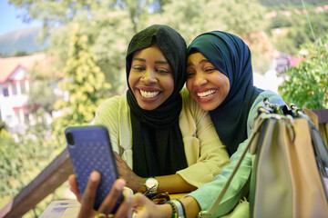 Middle Eastern Muslim Women Capturing Selfies in Serene Surroundings