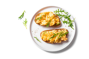 Scrambled eggs sandwiches with arugula microgreens