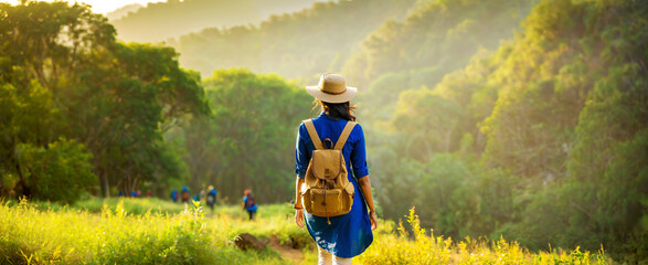 Young Indian Woman on Hiking Route Through Lush Forest Wearing Blue Kurti. Travel Concept.