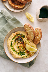 Delicious homemade hummus with lemon, paprika, olive oil and microgreens. Vegetarian Middle Eastern dish