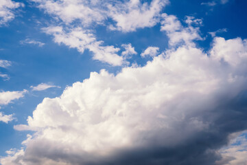 Large fluffy cumulus cloud in blue sky, nature background