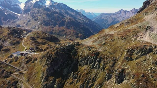 Sunsten Pass, Switzerland: Aerial drone footage of the dramatic landscape along the Susten pass in canton Uri and Bern in the alps on a sunny summer day in Switzerland. Shot with a tilt down motion