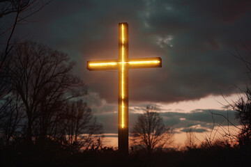 Illuminated cross against a colorful sunset sky with clouds