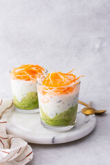 Healthy breakfasts and lunches, avocado and yogurt with chia, grated carrots and radishes in glass cups