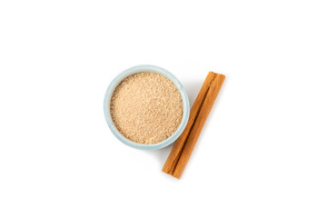Cinnamon sugar isolated on white background. Homemade cinnamon sugar in a bowl on background. Brown sugar. Spice mixture for drinks and baking.