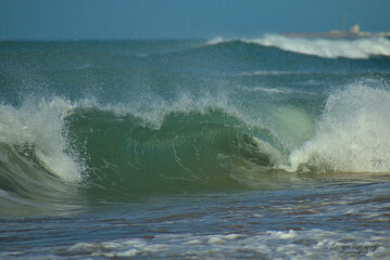 Sea wave breaking in the shape of a tunnel.