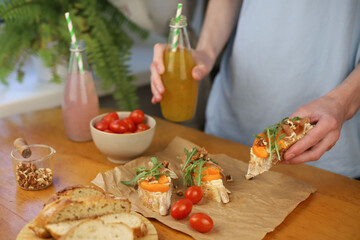 cooking Italian dish. bruschetta. in the photo, hands are preparing a dish of bread, herbs, jamon, cheese and honey. home-cooked lunch and dinner