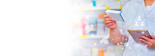 A pharmacist holds a mobile phone to receive a doctor's prescription, prepare medicine and check...