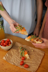 cooking Italian dish. bruschetta. in the photo, hands are preparing a dish of bread, herbs, jamon, cheese and honey. home-cooked lunch and dinner