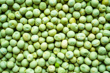 Background of a green peas grains close up. Food pattern.