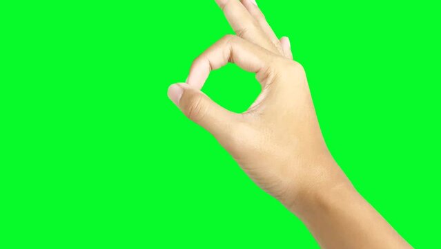Okay hand gesture isolated on green screen chroma key