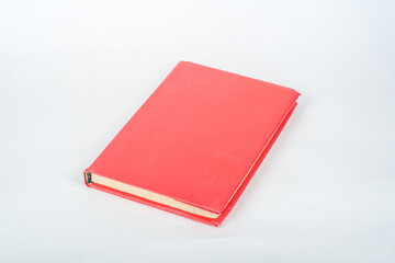 red book on a white table. Copy space for text.