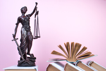 Law concept - Open law book, Judge's gavel, scales, Themis statue on table in a courtroom or law...