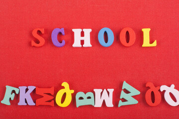 SCHOOL word on red background composed from colorful abc alphabet block wooden letters, copy space...