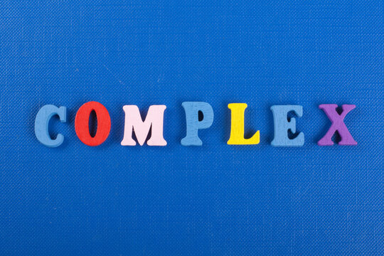 COMPLEX word on blue background composed from colorful abc alphabet block wooden letters, copy space for ad text. Learning english concept.