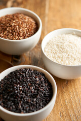 Rice varaties in bowls on wooden table