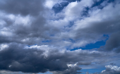 storm clouds float across the blue sky