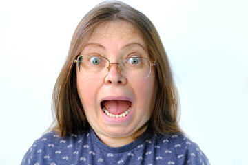 close-up of funny face, mature charismatic woman 50 years old with grimaces, screaming with wide...