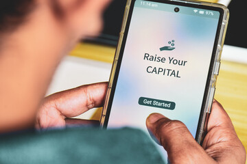 Businessman using mobile applications to raise capital for startup. Fundraising donation concept.