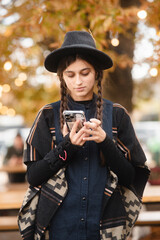 A stunning young lady radiating beauty in her black outfit and hat.