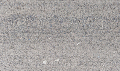 The dry land of the country road is mixed with sand and small black stones