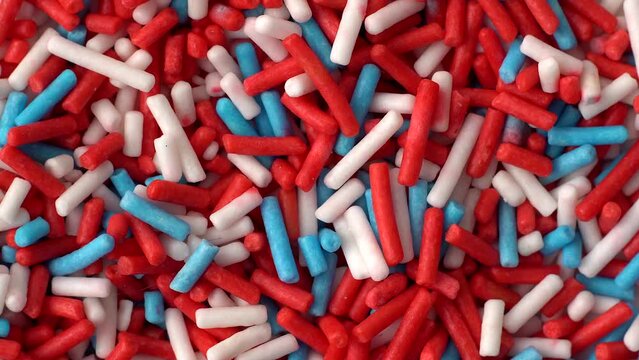 Macro video of colourful confetti kept on rotating disk.