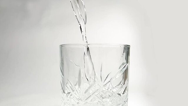 slow motion shot of pouring water into glass, drinking water in glass