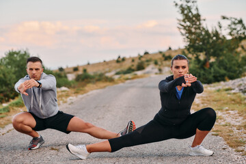 A Romantic Couple Stretching Down After a Run