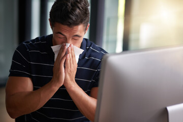 Sick, tissue and business man blowing nose at desk for sneeze, virus infection or flu bacteria....