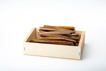 A wooden box filled with razor clams isolated on a white background, showcasing the seafood delicacy