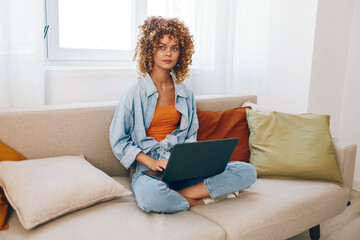 Smiling Woman Working on Laptop in Cozy Home Office