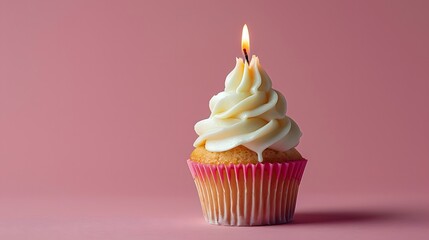 A cupcake with one candle on it, pink background. commercial advertising photography.
