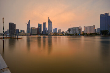 Obraz premium Ho Chi Minh City skyline and the Saigon River. Amazing colorful night view of skyscraper and other modern buildings at downtown. Travel concept