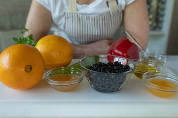 Healthy ingredients on a cutting board for making a fruit vegetable salad with black beans. Vegan...