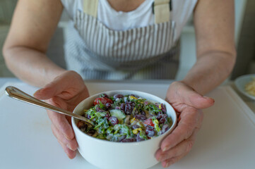 Fresh kidney bean salad with romaine lettuce, tomatoes, cucumber, onione and chives
