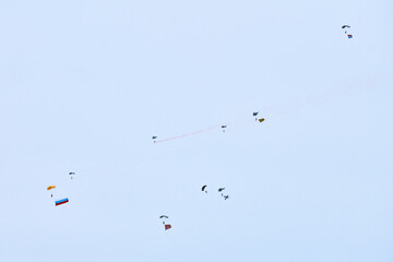 Airborne forces paratroopers soaring holding Flag of Russia and flags of military units, military...
