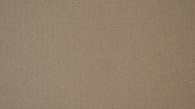 Brown corrugated cardboard paper texture background. Top view. Stop motion animation, 4k video